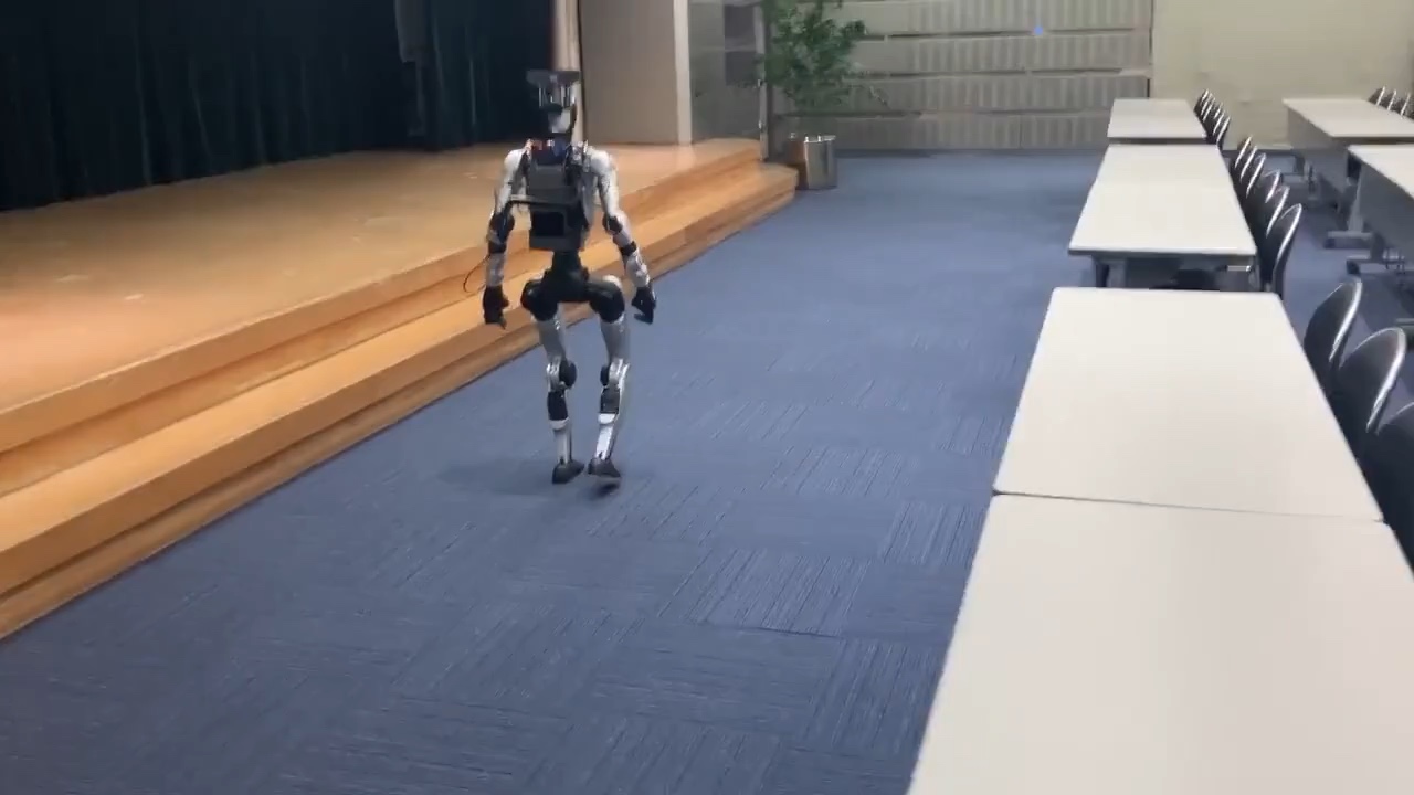 Unitree G1 humanoid robot collecting data in the conference hall used for VIREO's real-world experiments.